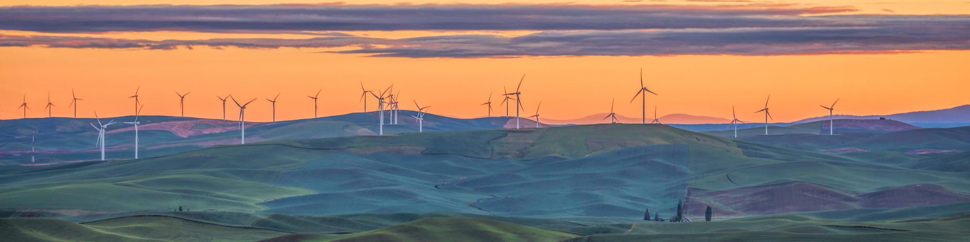 Sunset view of the rolling hills of the Palouse and wind turbines seen from Steptoe Butte