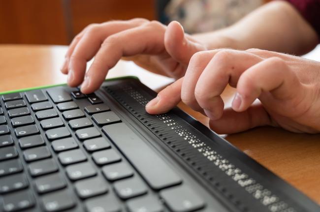 A person typing on a keyboard